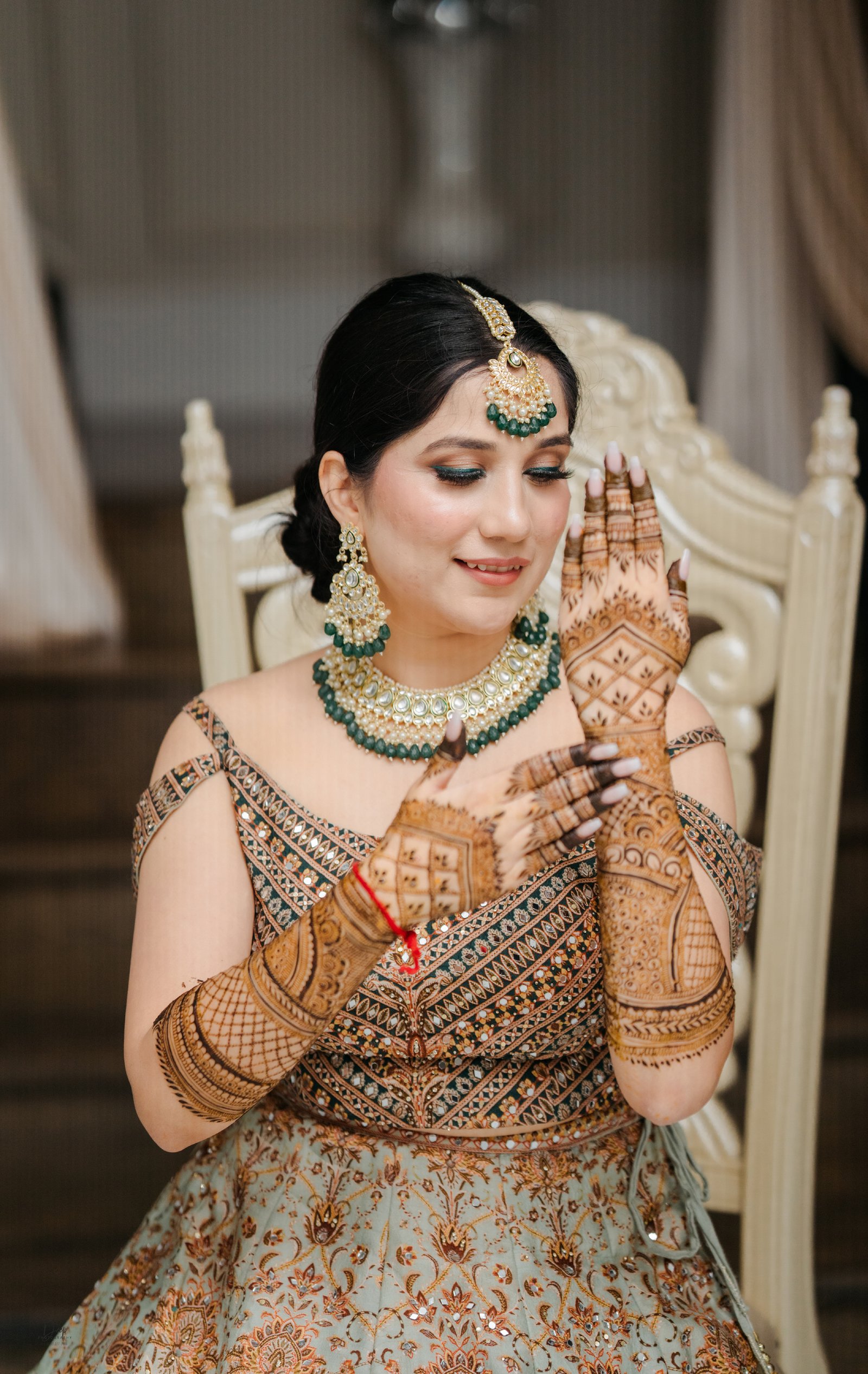 Traditional Mehndi design on bride’s hands during ceremony
